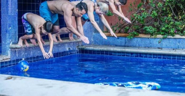 Casa Luna owners Al and Agatha Doerksen daughter Susan (second from left) and her family take an enthusiastic dive in the rental home's tiled pool.