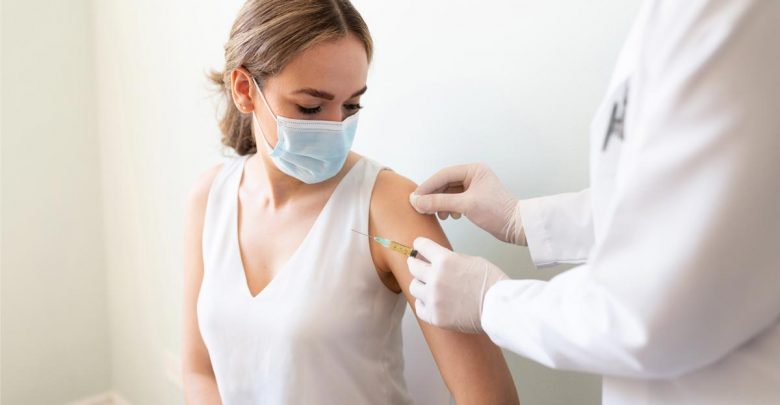 A woman gets vaccinated.