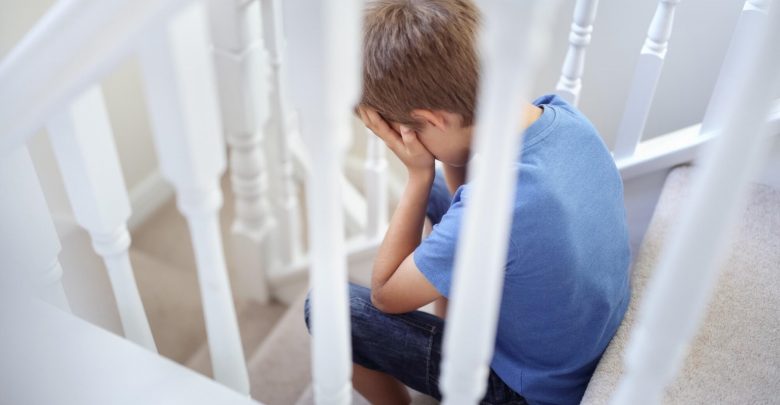 sad child sitting on stairs