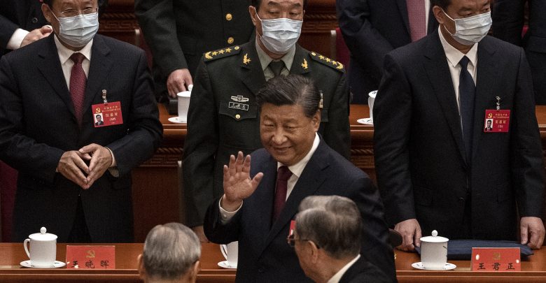 Chinese President Xi Jinping (center) waves to senior members of the government as he leaves at the end of the opening ceremony of the 20th National Congress of the Communist Party of China at The Great Hall of People in Beijing on Sunday.