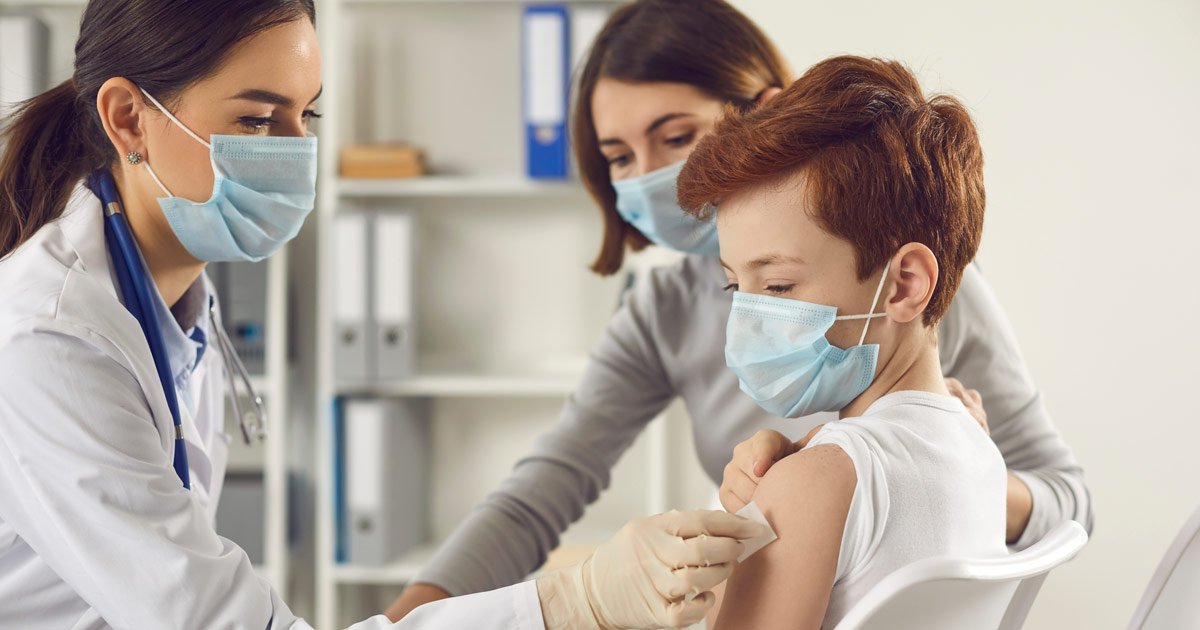 doctor giving boy a shot