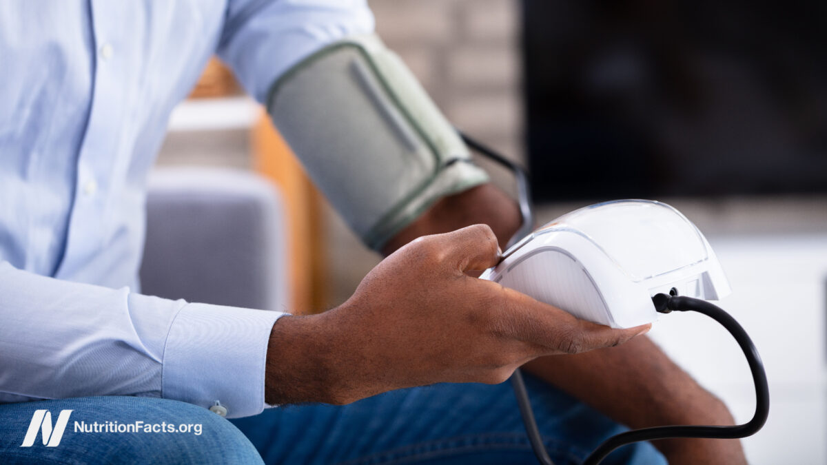 person using a blood pressure monitor